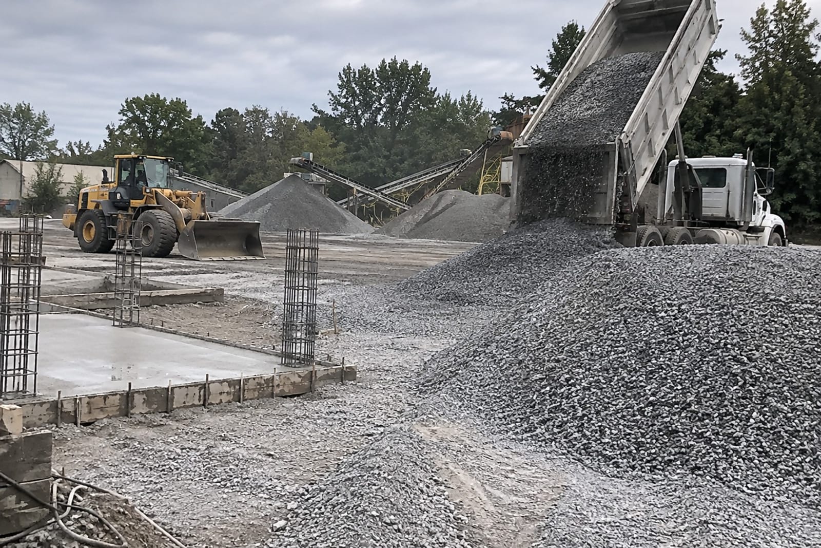 Crushed stone delivery and formed concrete pads at a Pittsburgh concrete and gravel job
