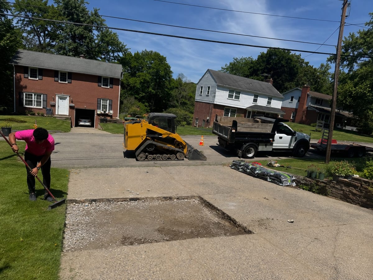 Failed driveway section cut out and broken down to gravel base in Pittsburgh