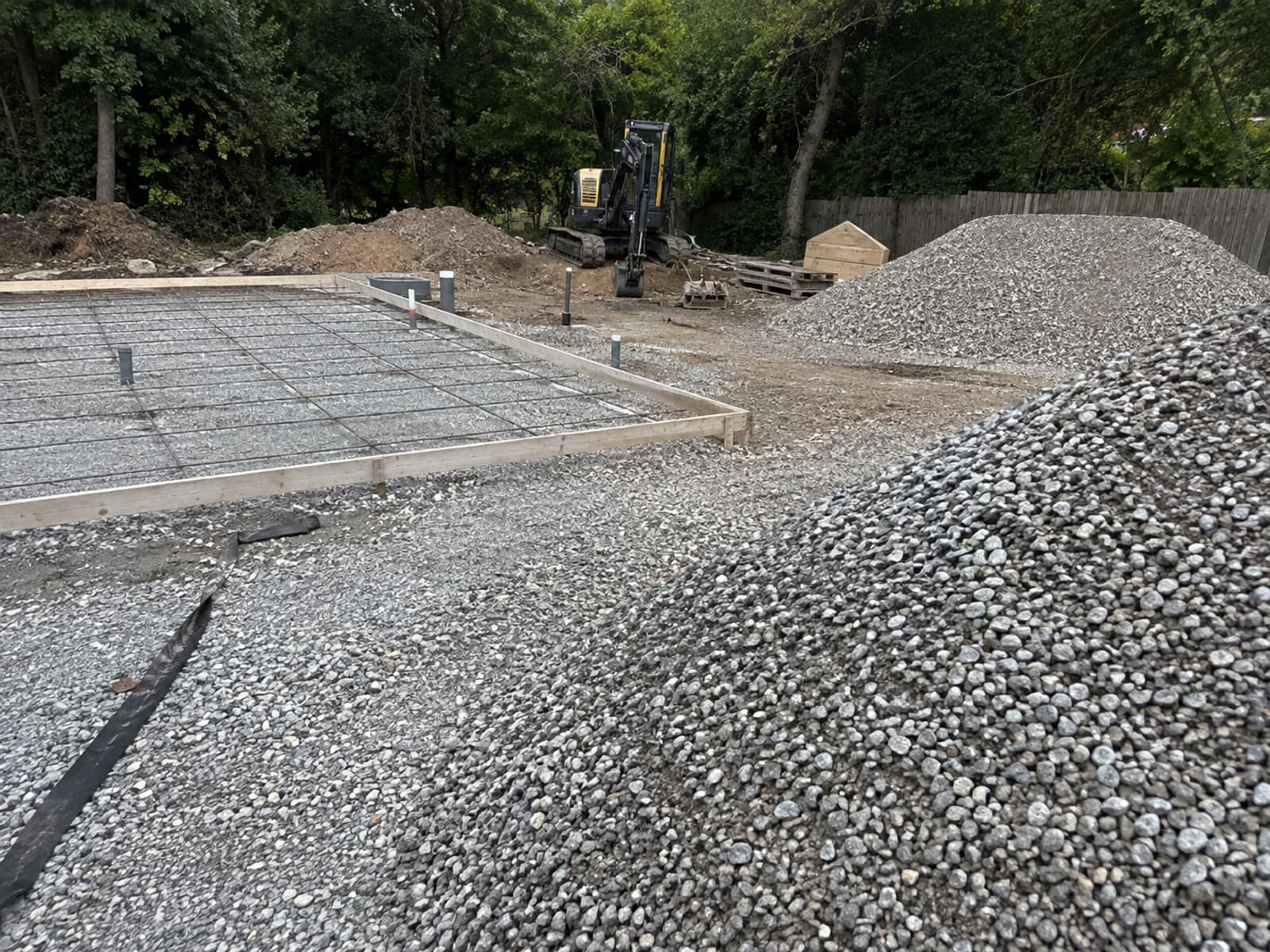 Compacted gravel base with formwork and rebar set ready for a concrete pour in Pittsburgh