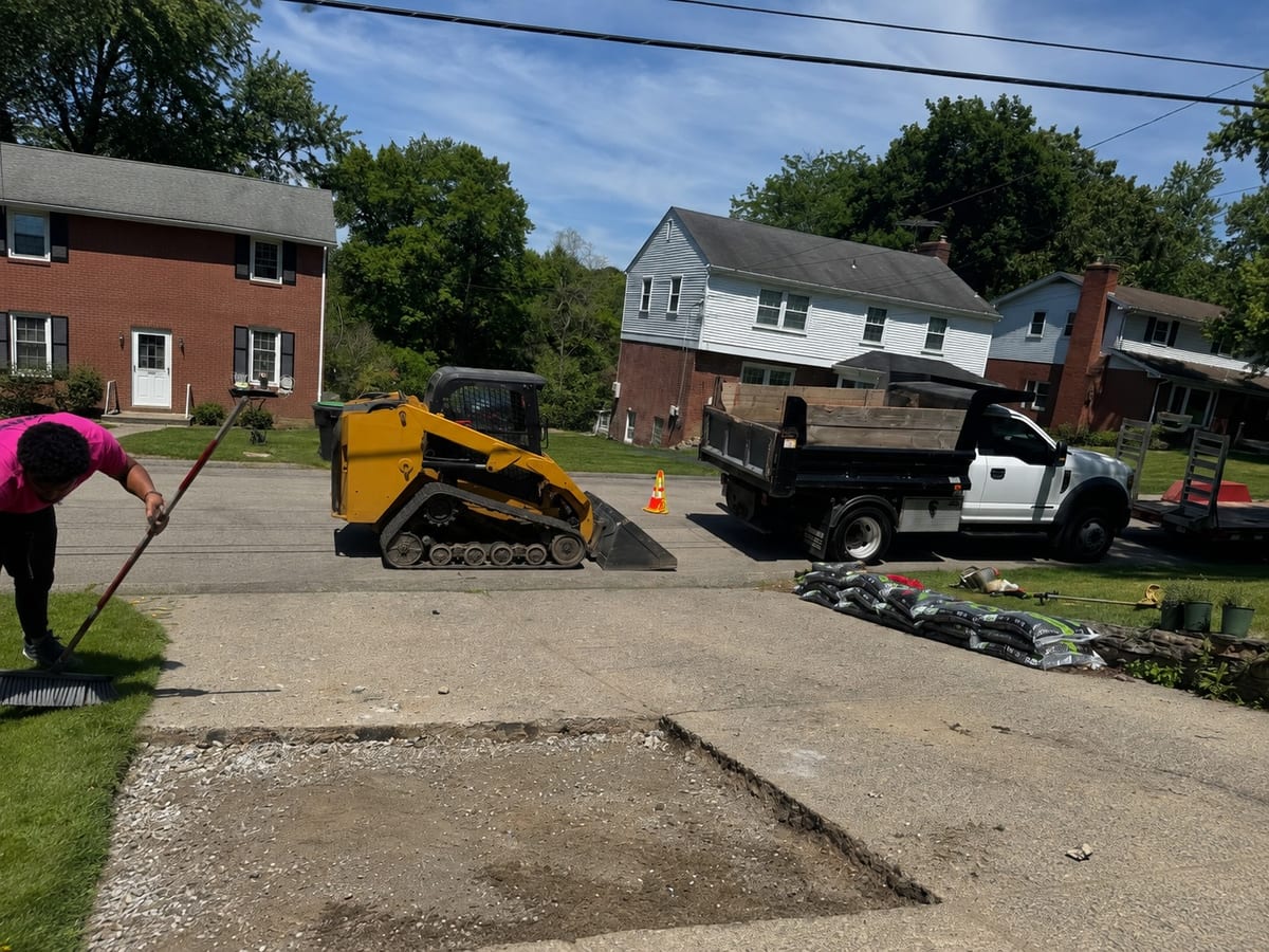Excavated concrete repair area with the base graded and crew on site in Pittsburgh